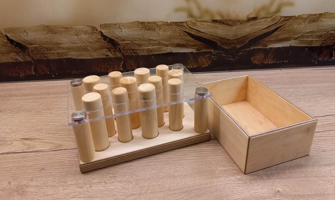Montessori depth perception pegboard with a clear top, wooden pegs and a birch tray.